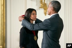 FILE - President Barack Obama awards the 2014 National Humanities Medal to author Jhumpa Lahiri of New York, during a ceremony in the East Room at the White House in Washington, Sept. 10, 2015. (AP Photo/Andrew Harnik)