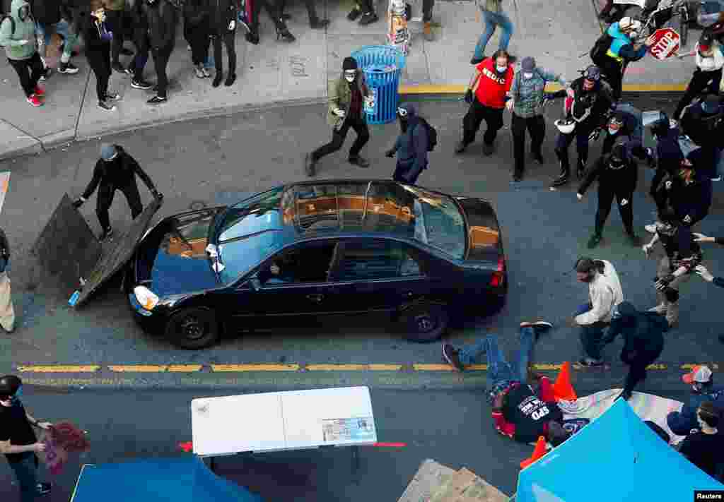 A man falls after being shot by a driver who tried to drive through a protest against racial inequality in Seattle, Washington, June 7, 2020.