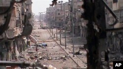 This citizen journalism image provided by Shaam News Network SNN and taken on Thursday, June 21, 2012, purports to show a general view of a damaged street in the Khaldiyeh neighborhood of Homs province, central Syria. (AP Photo/Shaam News Network, SNN)THE