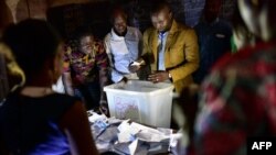 Electoral officials count ballot papers at the polling station on July 29, 2018 in Bamako, during Malian presidential elections. 