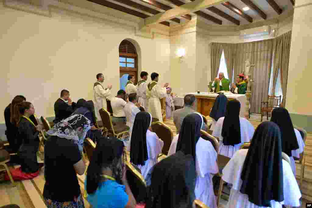 Pope Francis, background center at the altar, celebrates a Mass with Cardinal Charles Maung Bo at the archbishop&#39;s palace in Yangon, Nov. 28, 2017.