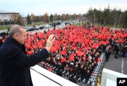 Turkey's President Recep Tayyip Erdogan waves to a group of workers at the airport in Ankara, Turkey, Dec. 7, 2017 prior to his departure on a two-day official visit to Greece.