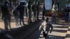 Opposition leader Jameson Timba walks after disembarking a prison truck as he arrives for bail application at the Harare Magistrates' court