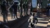 Opposition leader Jameson Timba walks after disembarking a prison truck as he arrives for bail application at the Harare Magistrates' court