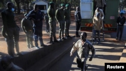 Opposition leader Jameson Timba walks after disembarking a prison truck as he arrives for bail application at the Harare Magistrates' court