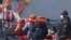 A Border Force vessel brings a group of people thought to be migrants into the port city of Dover, England, from small boats, Aug. 8, 2020.