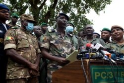 FILE - Colonel-Major Ismael Wague, center, spokesman for the soldiers identifying themselves as National Committee for the Salvation of the People, speaks during a press conference at Camp Soudiata in Kati, Mali, Aug. 19, 2020.