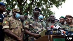 Malian Air Force deputy chief of staff Ismael Wague, front row 2nd left, speaks during a press conference in Kati, Mali, Aug. 19, 2020. 