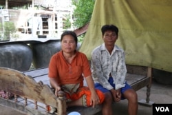 Keo Eat, 52, a deputy Prey Khla commune chief, decided to join the ruling Cambodian People’s Party after being served with a court summons shortly before the deadline to defect. He's shown with his wife, Keo Sarin.