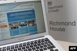 This photograph, posed as an illustration on May 12, 2017, shows the website of the NHS: East and North Hertfordshire notifying users of a problem in its network taken outside the Department of Health in London.