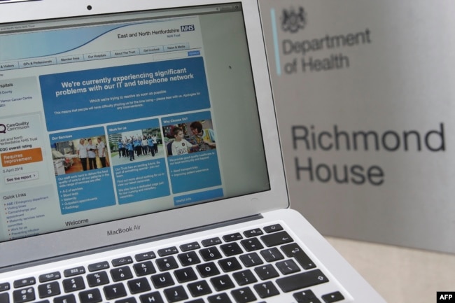 This photograph, posed as an illustration on May 12, 2017, shows the website of the NHS: East and North Hertfordshire notifying users of a problem in its network taken outside the Department of Health in London.