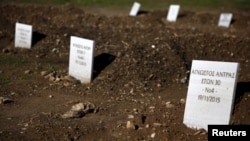 Tombstones are placed on graves of unidentified refugees and migrants who drowned at sea during an attempt to cross a part of the Aegean Sea from the Turkish coast, at a cemetery near the village Kato Tritos on the Greek island of Lesbos, Feb. 6, 2016. 