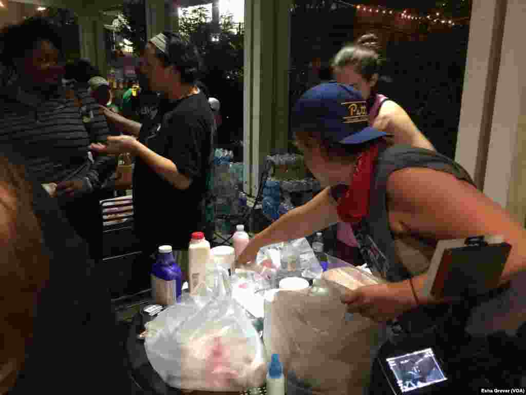 Volunteers hand out water, masks and milk for tear gas as protestors head out to march in Charlotte, North Carolina, Sept. 22, 2016. Charlotte saw a third night of protests following the police shooting death of an African-American man earlier this week.