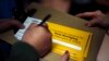 A person signs up to caucus for Democratic presidential candidate former South Bend, Ind., Mayor Pete Buttigieg, following a town hall meeting in Fort Dodge, Iowa, Jan. 25, 2020. 