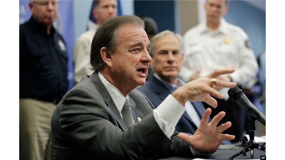 Commissioner John Sharp, left, and Texas Gov. Greg Abbott, right, speak to the media following a briefing on Hurricane Harvey recovery efforts at the new Federal Emergency Management Agency Joint Field Office, Sept. 14, 2017, in Austin, Texas.