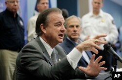 Commissioner John Sharp, left, and Texas Gov. Greg Abbott, right, speak to the media following a briefing on Hurricane Harvey recovery efforts at the new Federal Emergency Management Agency Joint Field Office, Sept. 14, 2017, in Austin, Texas.