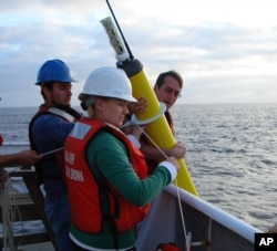 This photo provided by NOAA Corps shows the deployment of an Argo float to capture ocean temperature data.