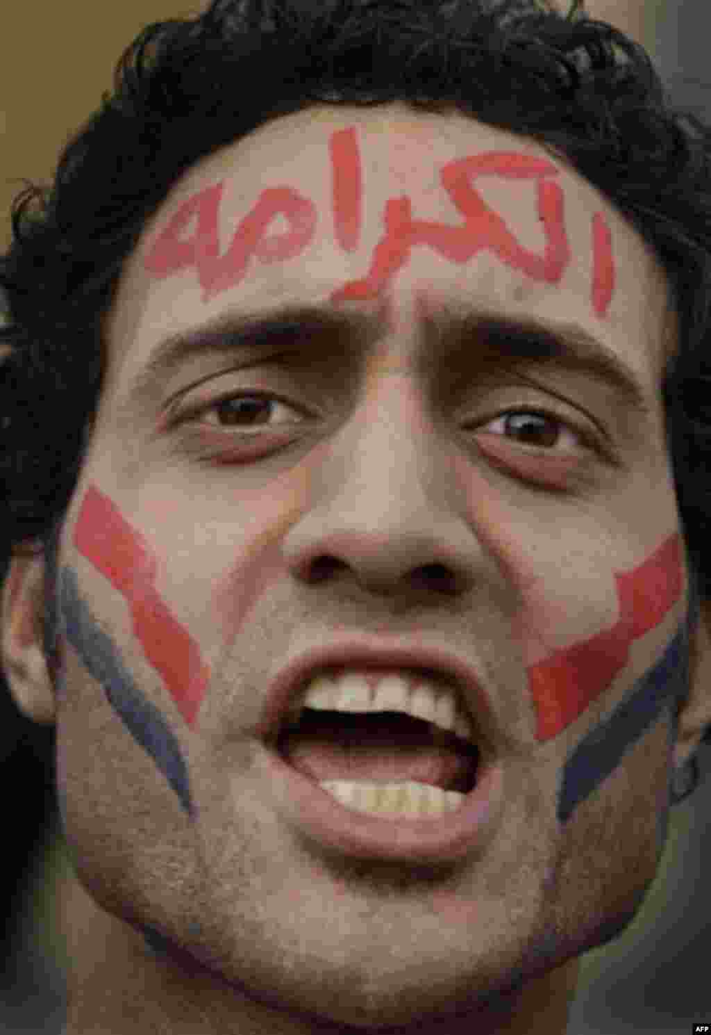 An anti-government protester wearing facepaint in arabic reading "Dignity" shouts slogans against Egyptian President Hosni Mubarak during the continuing demonstration in Tahrir square in downtown Cairo, Egypt, Tuesday, Feb. 1, 2011. More than a quarter-mi