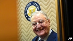 FILE - Former Vice President Walter Mondale smiles as he gets on an elevator on Capitol Hill in Washington, Jan. 3, 2018.