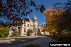 Students walk into Maxwell Hall at Indiana University in Bloomington, Indiana.