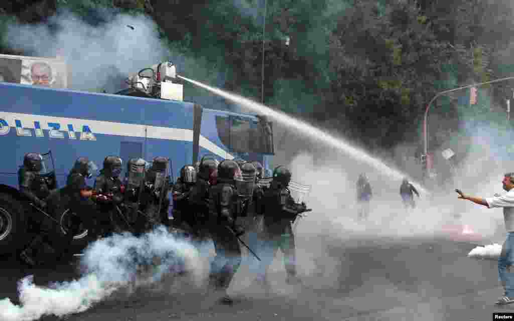 Anti-riot police use water cannon against protesters during a demonstration in Naples, Italy. Hundreds of protesters faced off riot police outside the Capodimonte Palace. The European Central Bank is holding on of its regular rate-setting meetings. 