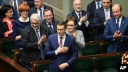 New Polish Prime Minister Mateusz Morawiecki (C) thanks lawmakers for applause after giving his policy speech in the parliament in Warsaw, Poland, Dec. 12, 2017.