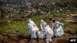 Members of the Congolese Red Cross carry body bags containing human remains during a mass burial for victims of the clashes in eastern Democratic Republic of Congo, at Musigiko cemetery in Bukavu on Feb. 20, 2025.