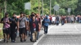 Migrants walk through Tapachula, Chiapas state, Mexico, Nov. 20, 2024, hoping to reach the U.S. border.