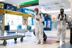 Para penumpang dari London tiba di Bandara Internasional JFK di New York, di tengah pembatasan baru untuk mencegah virus corona (COVID-19), 21 Desember 2020. (Foto: Eduardo Munoz/Reuters)