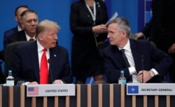 FILE - U.S. President Donald Trump and NATO Secretary General Jens Stoltenberg participate in a round table meeting during a NATO leaders meeting, Dec. 4, 2019.