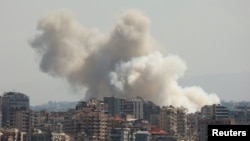 Smoke billows over southern Lebanon following Israeli strikes, as seen from Tyre, southern Lebanon