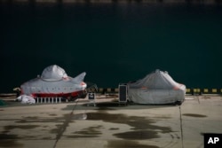 Two submersibles stand ready to join the search for bodies and fragments of the crashed plane, on a pier just outside Sochi, Russia, Dec. 26, 2016.