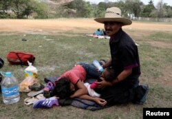 Central American migrants take a break from traveling in their caravan, as they journey to the U.S., in Matias Romero, Oaxaca, Mexico, April 3, 2018.