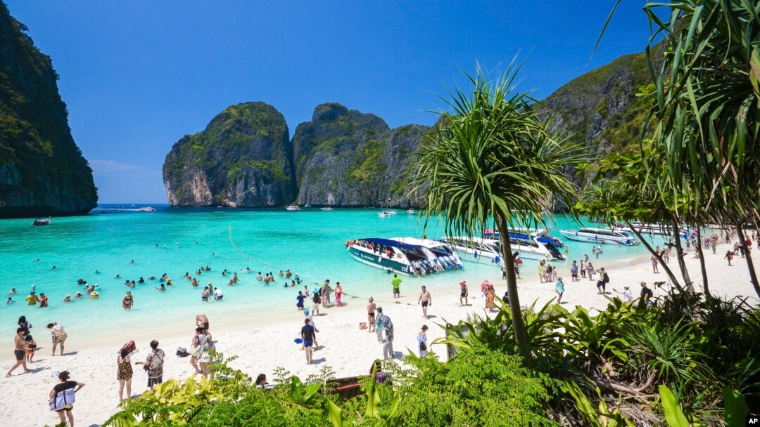 FILE - Tourists enjoy the popular Maya bay on Phi Phi island, Krabi province, March 4, 2017.