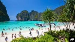 FILE - Tourists enjoy the popular Maya bay on Phi Phi island, Krabi province, March 4, 2017.