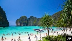FILE - Tourists enjoy the popular Maya bay on Phi Phi island, Krabi province, March 4, 2017.