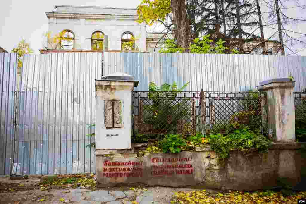 A makeshift wall blocks off an abandoned mansion in the center of Chisinau, Moldova's capital. About one third of working age Moldovans have left the country to find work. The money sent home accounts for 25 percent of the country's GNP. (Vera Undritz for