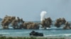 Smoke rises from an amphibious assault vehicles (AAV) participating in an amphibious assault exercise as part of the "Cobra Gold 2025” (CG25) joint military exercise at a military base in Chonburi province, Thailand, March 3, 2025. 