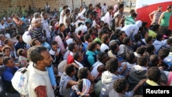 Migrants are seen after they were relocated from government-run detention centers, after getting trapped by clashes between rival groups in Tripoli, Libya, Sept. 4, 2018.