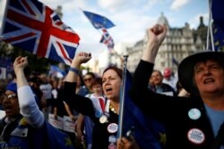 FILE - Anti-Brexit protesters demonstrate outside the Houses of Parliament in London, Sept. 4, 2019.