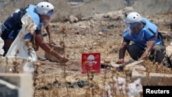 Civil defense members prepare to safely detonate cluster bombs in the rebel-held area in Deraa, Syria, July 26, 2017. 