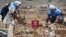 Civil defense members prepare to safely detonate cluster bombs in the rebel-held area in Deraa, Syria, July 26, 2017. 