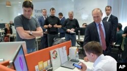 FILE - Russian President Vladimir Putin, right, visits the country's largest internet search engine Yandex headquarters in Moscow, Sept. 21, 2017.