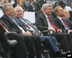 From left, former Polish Presidents Aleksander Kwasniewski and Lech Walesa are seated with Canadian Prime Minister Stephen Harper and Poland Prime Minister Donald Tusk at Freedom Day celebrations in Warsaw, Poland, June 4, 2014.