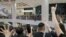 FILE - Pro-democracy demonstrators hold flags to call for independence during a vigil for a protester Marco Leung Ling-kit, who fell to his death during a demonstration outside the Pacific Place mall a year ago, in Hong Kong, China, June 15, 2020. 