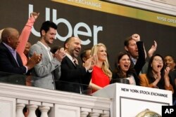 Uber CEO Dara Khosrowshahi, third from left, is seen at the opening bell ceremony at the New York Stock Exchange, as the ride-hail giant makes its initial public offering, May 10, 2019.