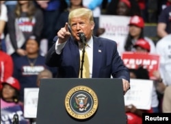 FILE - Then-President Donald Trump holds a campaign rally in Colorado Springs, Colorado, Feb. 20, 2020.