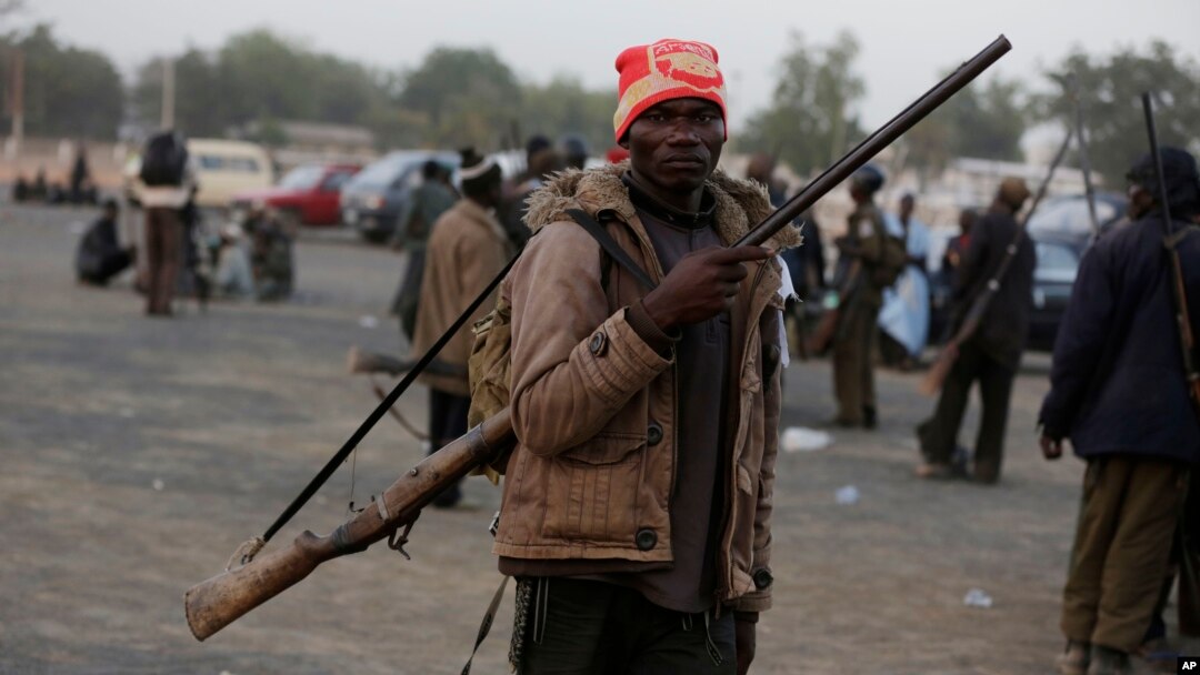 FILE - Boko Haram fighters have sized a multinational military base in the Nigerian town of Baga. In some areas where the Islamist extremists have been active, local hunters and vigilantes have taken up arms to defend themselves.
