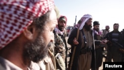 FILE - Yazidi fighters gather at Mount Sinjar as they head to battle Islamic State militants in Iraq, Dec. 21, 2014. IS swept into Sinjar town and surrounding villages in early August; hundreds of Yazidi women and girls were taken captive and turned into sex slaves.