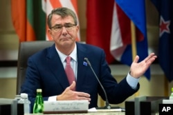FILE - Defense Secretary Ash Carter opens the Global Coalition to Counter IS Meeting at Joint Base Andrews, Maryland, outside of Washington, D.C.